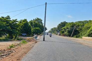 An electric pole obstructs a newly tarred road in Ballari, sparking safety alarms